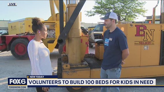 Volunteers pitch in to build 100 beds for kids in need