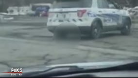 Video shows police running over possibly rabid raccoon