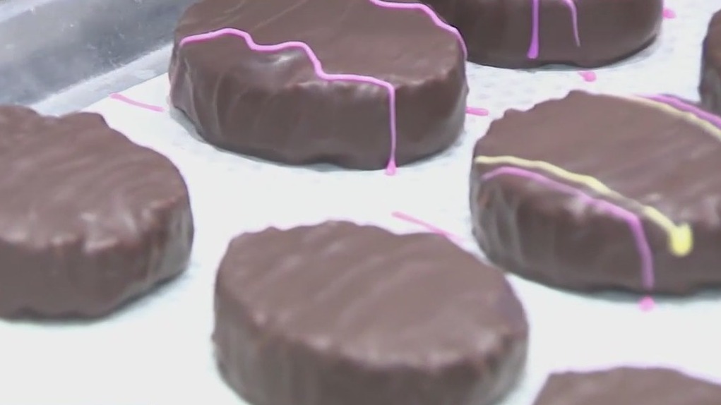 Witness hand decorating chocolates