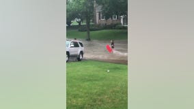 Residents in Ellicott City boogie board through flood waters