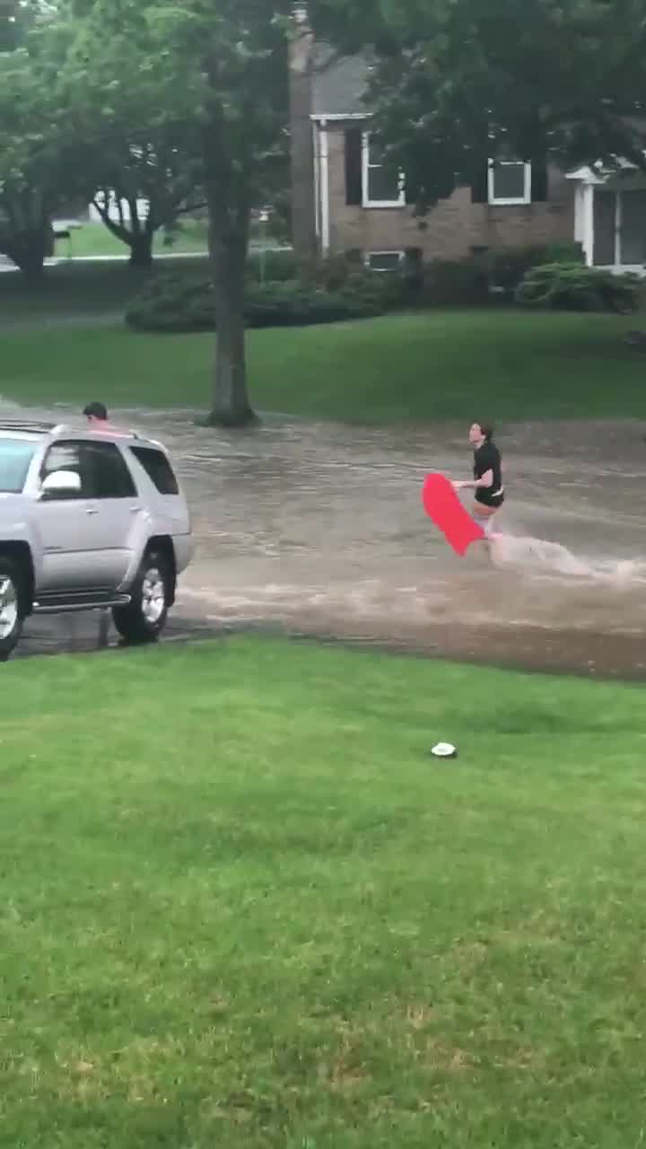 Residents in Ellicott City boogie board through flood waters
