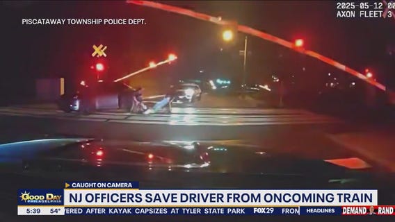 NJ officers save driver from oncoming train