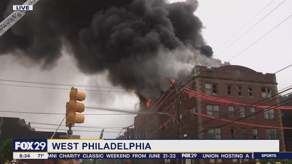 Firefighters battle 4-alarm apt building fire