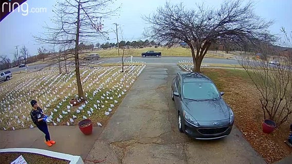 Woman places flags in yard in memory of Oklahoma COVID-19 deaths