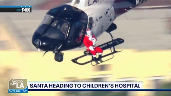 Santa gets ride on LAPD chopper to deliver presents