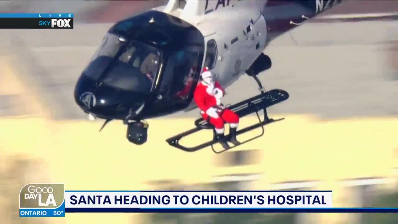Santa gets ride on LAPD chopper to deliver presents
