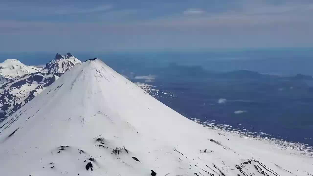 Aerial video shows Shishaldin Volcano in Alaska erupting lava
