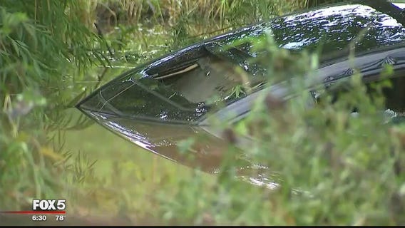 Woman escapes after car is swept away by flooding