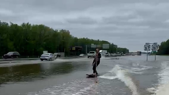 Arkansas floods provide entertainment for enthusiastic surfboarder
