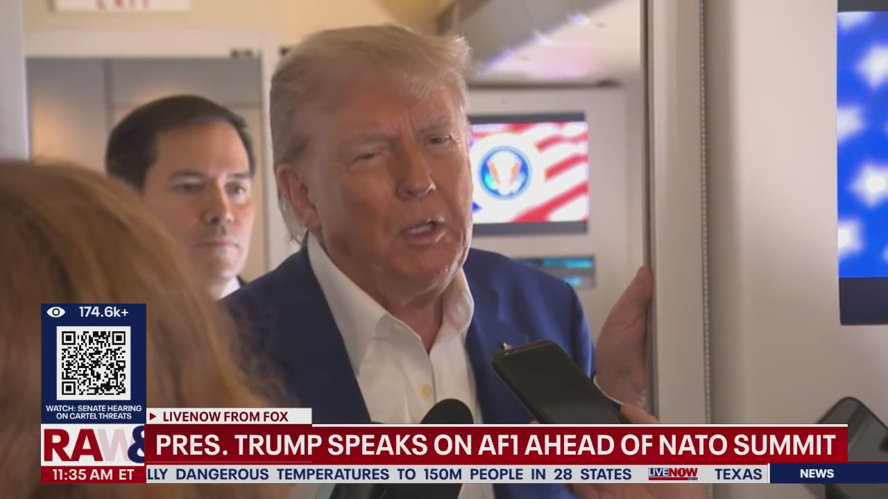 President Trump speaks to reporters on Air Force One