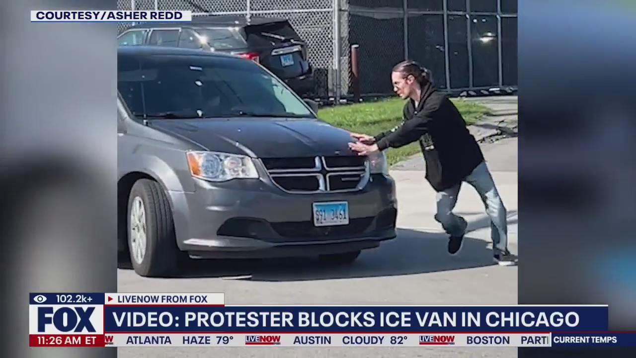 Video: Protestor blocks ICE van in Chicago