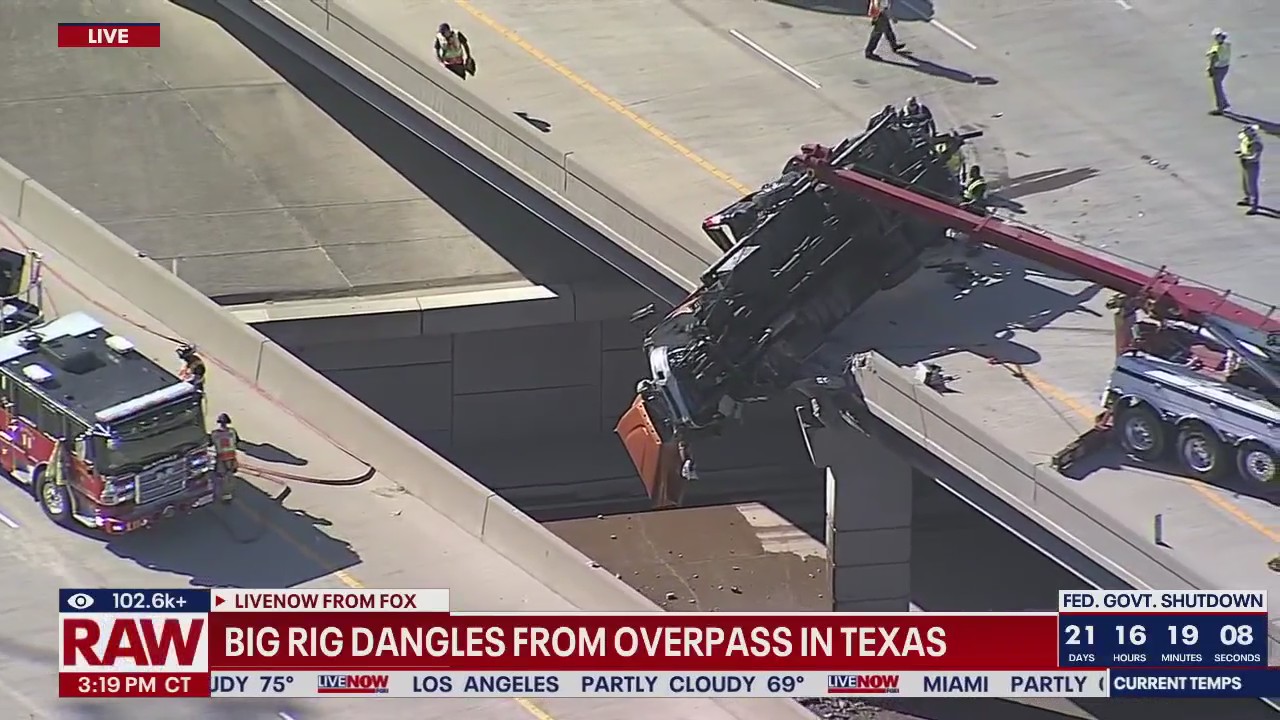 Breaking: Truck dangles from overpass in TX
