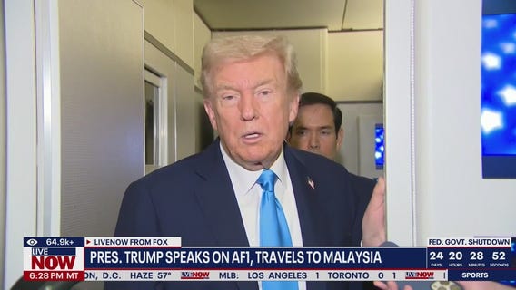 Trump speaks on Air Force One, travels to Malaysia