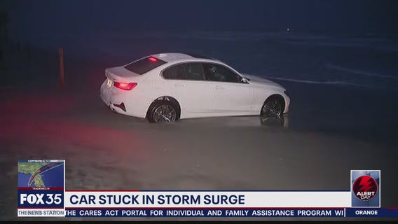 Car stuck in sand after rising tide