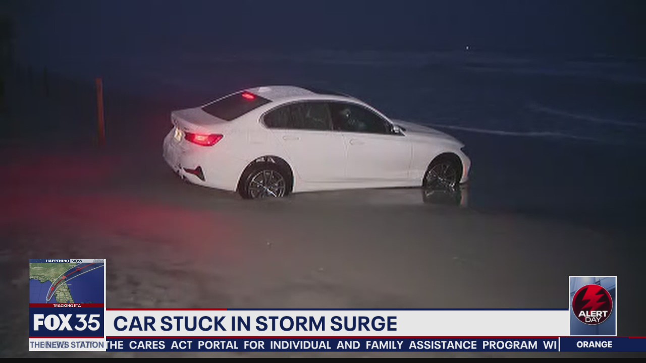 Car stuck in sand after rising tide