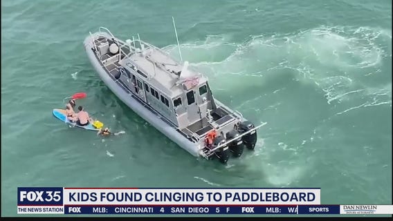 Kids found clinging to paddleboard one mile off coast