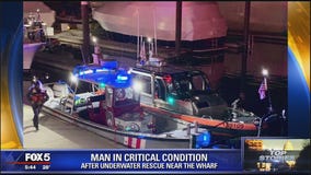 Crews attempt to rescue man from water near the Wharf