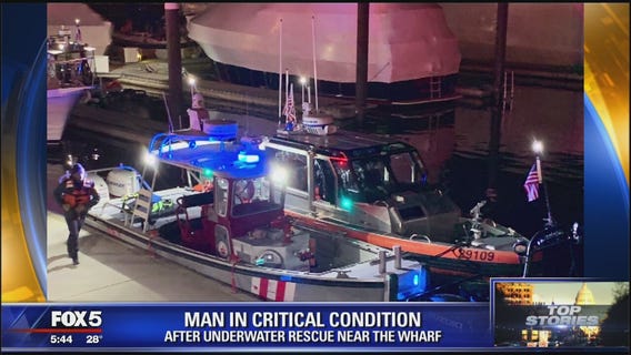 Crews attempt to rescue man from water near the Wharf