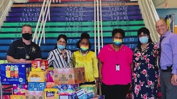 Mother of fallen Orange County Sheriff's Deputy Norm Lewis helps fill school pantries