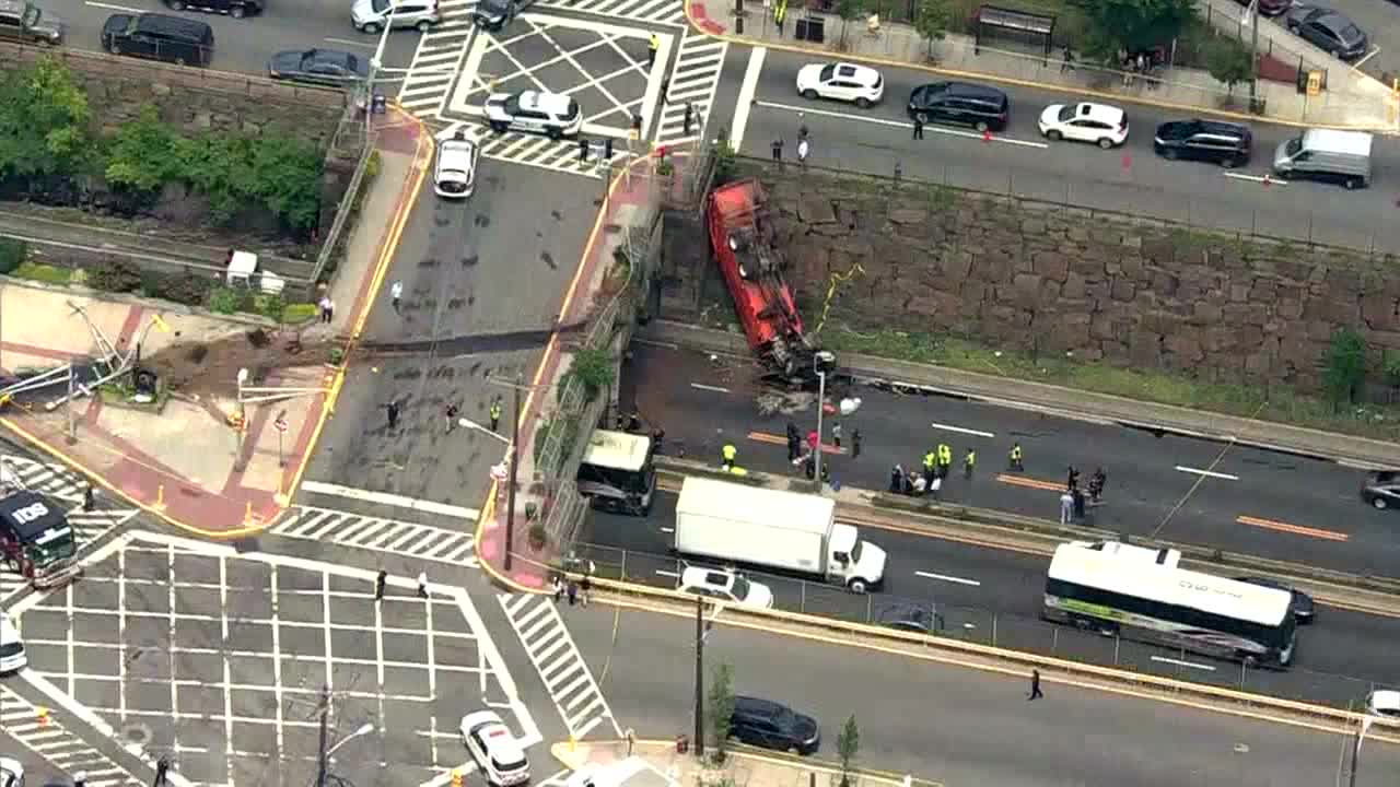 Dump truck comes off overpass