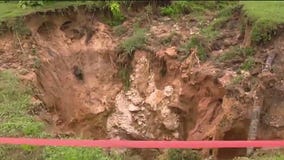 Massive hole opens inches away from home