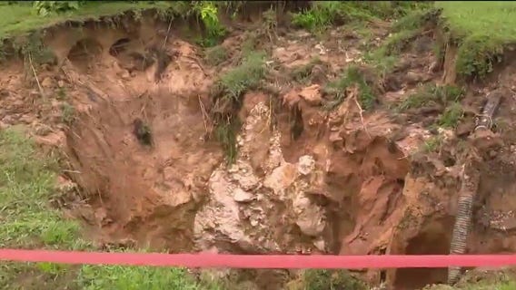 Massive hole opens inches away from home