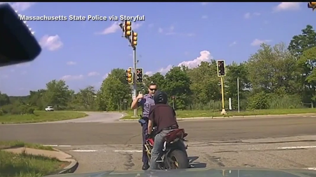 Driver pushes state trooper into traffic