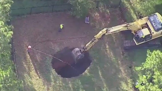 Crews begin filling in deadly sinkhole