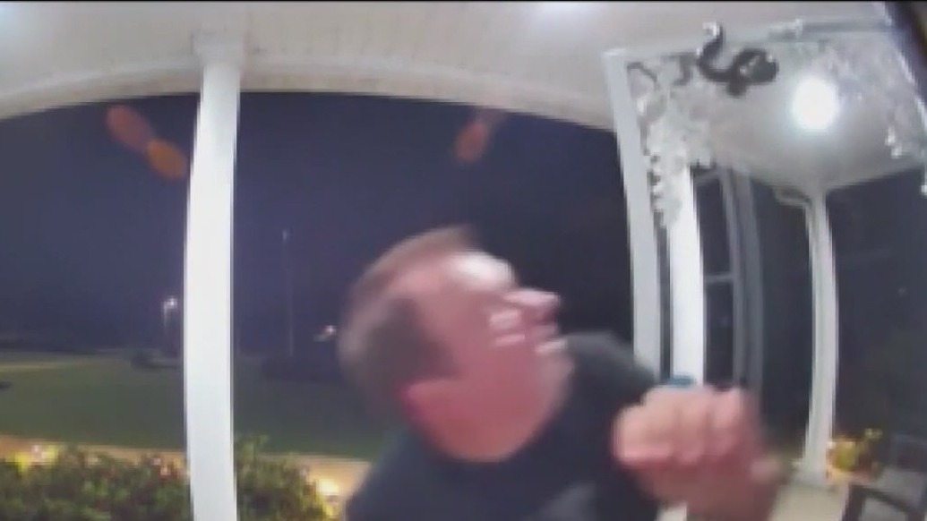 Man bitten by snake hanging on top of door