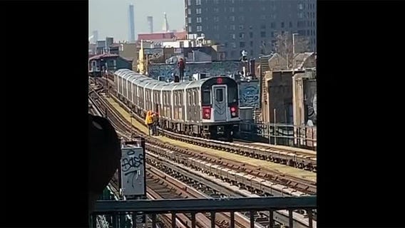 Two men are seen subway surfing in Queens