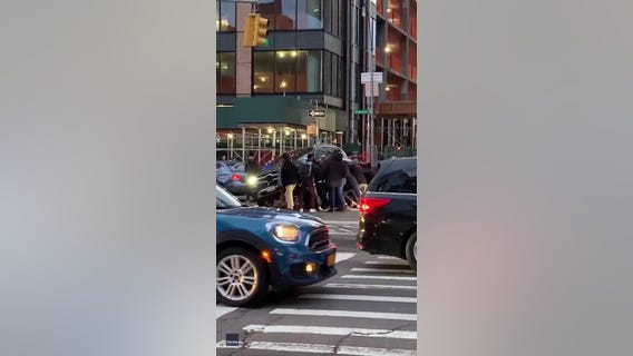 Crowd lifts vehicle to free trapped woman