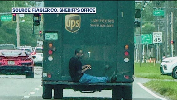 Suspect rides on back of UPS truck