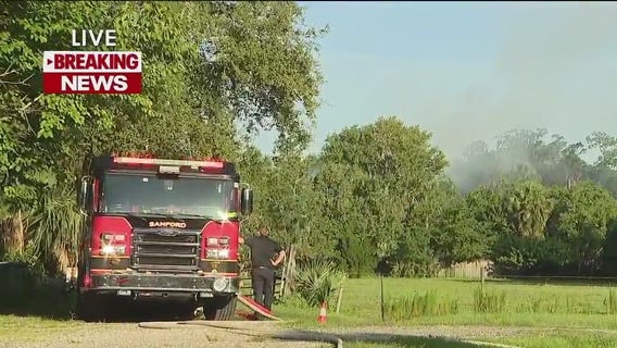 Crews battle house fire in Sanford