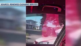 Driver speeds through traffic with man on windshield