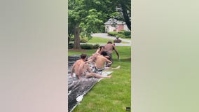 UPS driver takes break from deliveries to join teens on Slip N' Slide