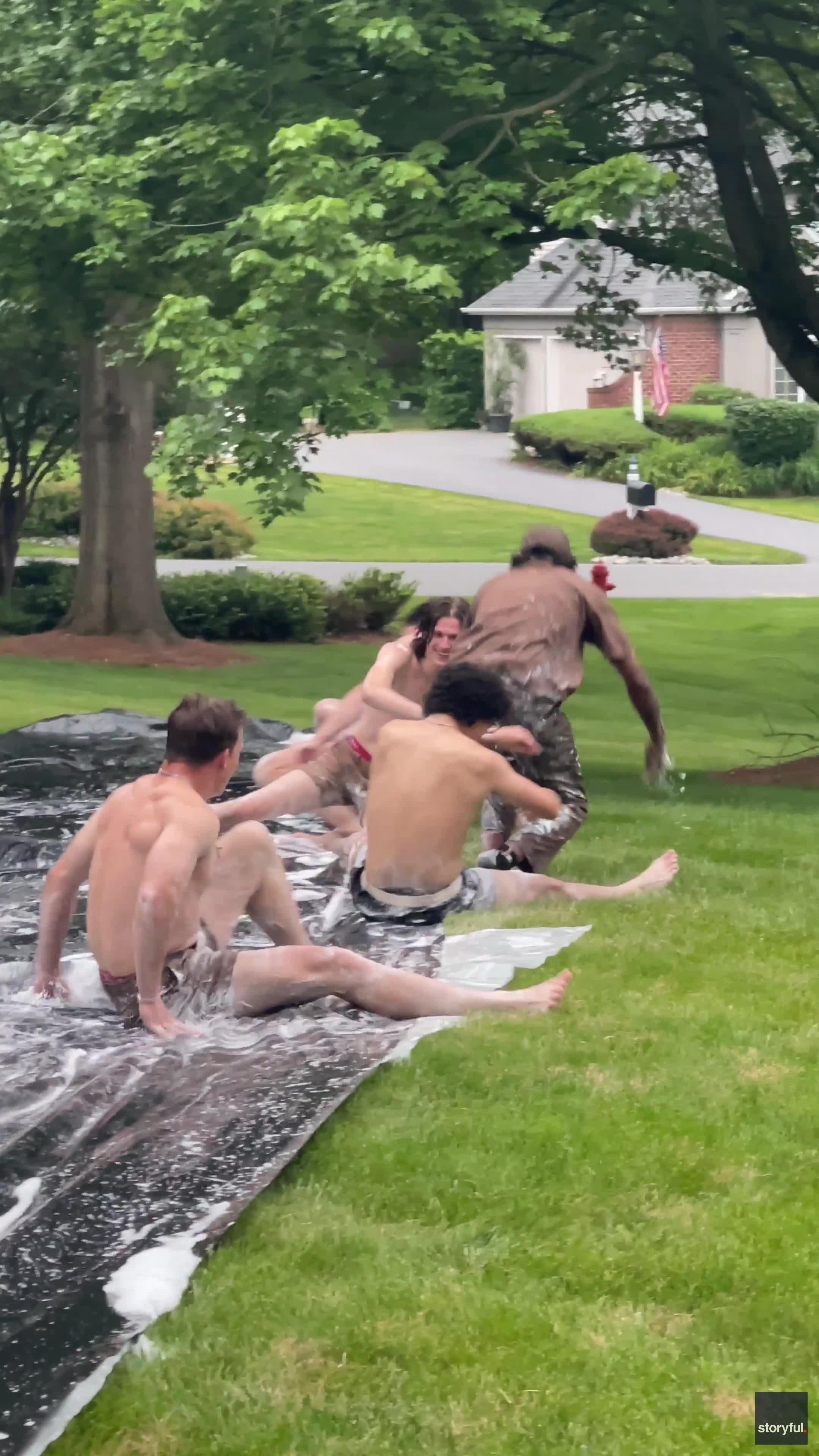 UPS driver takes break from deliveries to join teens on Slip N' Slide
