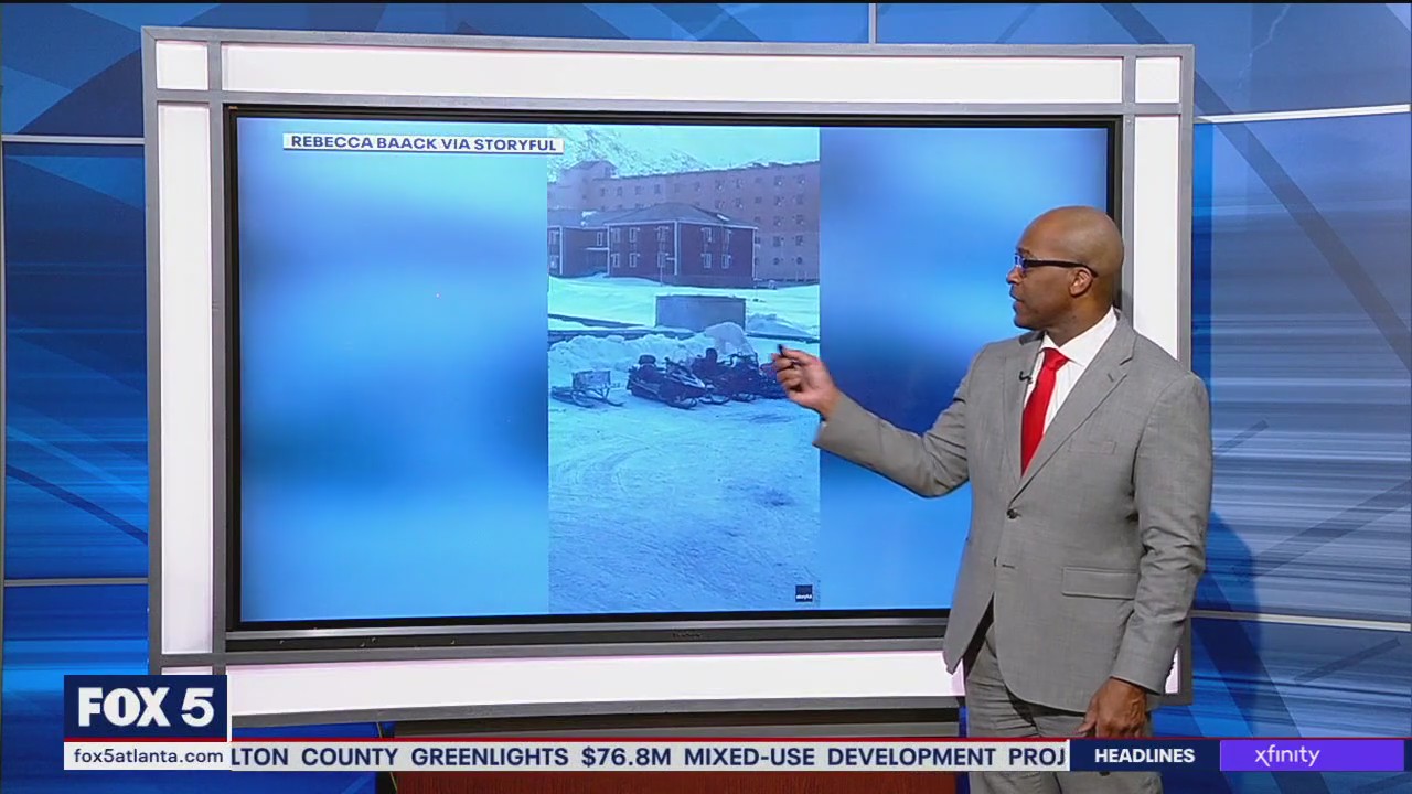 Man jumps on snowmobile to flee polar bear