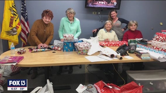 Volunteers give presents to deployed troops