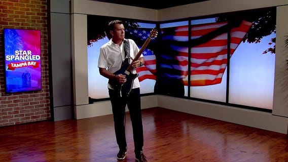 Mark Wilson plays national anthem on guitar