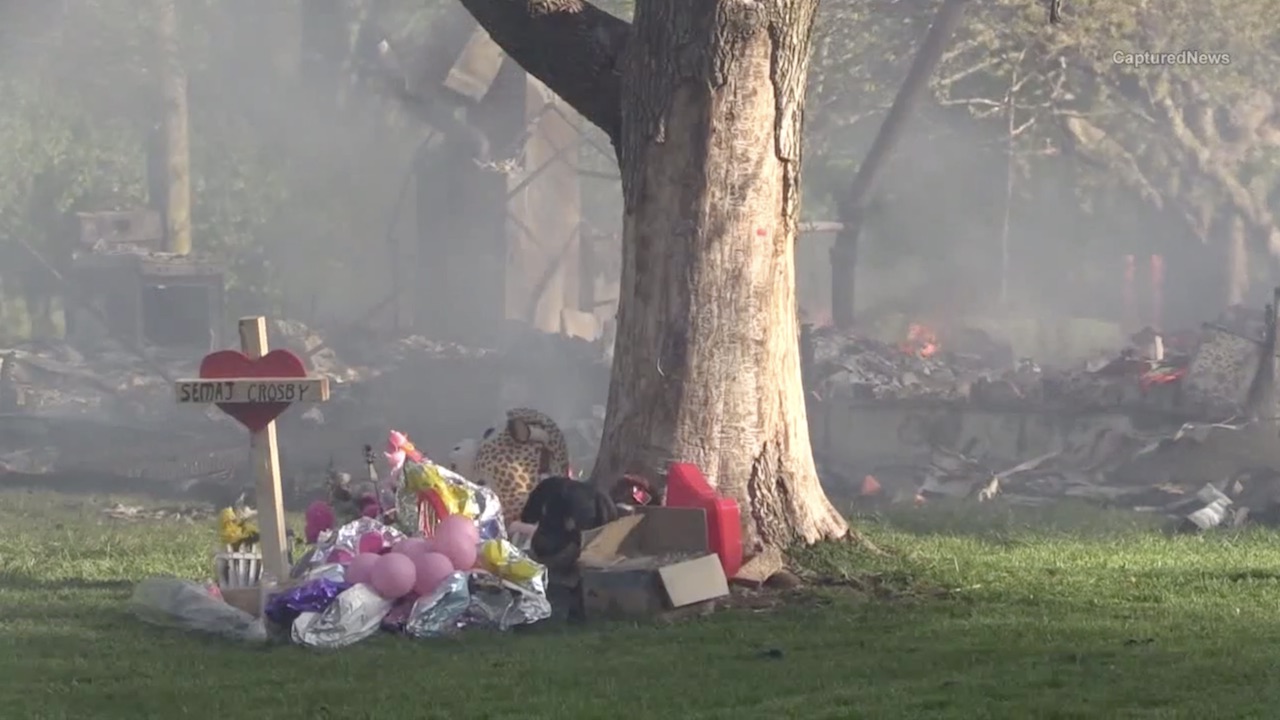 Home where toddler found dead under couch burns to ground