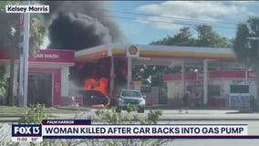 Woman killed after car backs into gas pump, starts fire