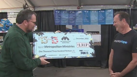 Charley presents $13 for 13 check to Metro Ministries