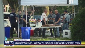 Search warrant served at suburban home after bodies found in yard