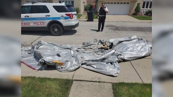 Airplane's emergency slide falls into Chicago backyard