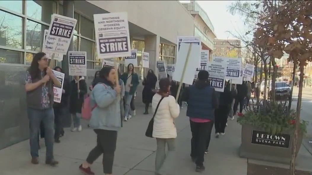 Workers at Howard Brown Health Clinic walk the picket line