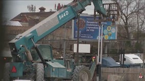 Brighton Park residents rally against migrant camp as construction equipment arrives