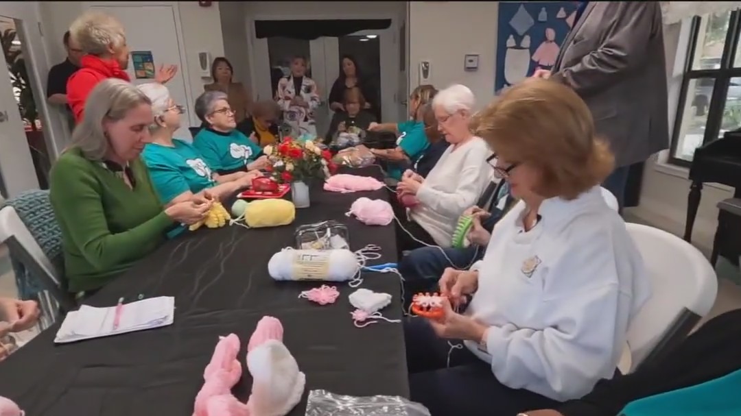 Seniors making beanies for premature babies