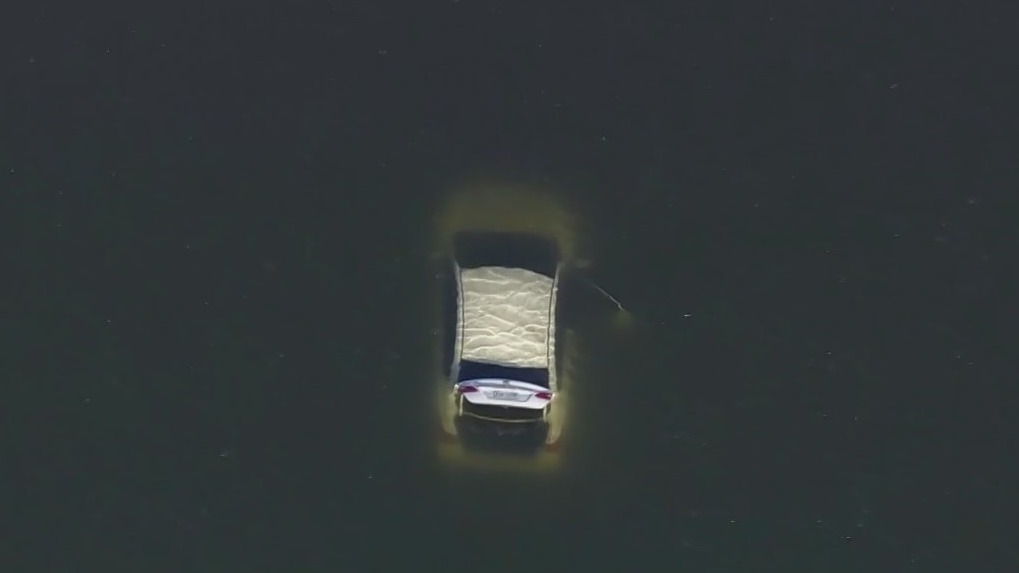 Man rescued after driving car into bay