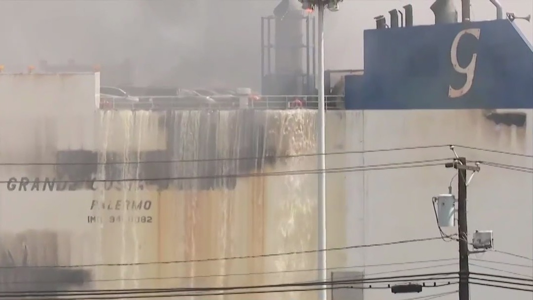 Fatal cargo ship fire still burning