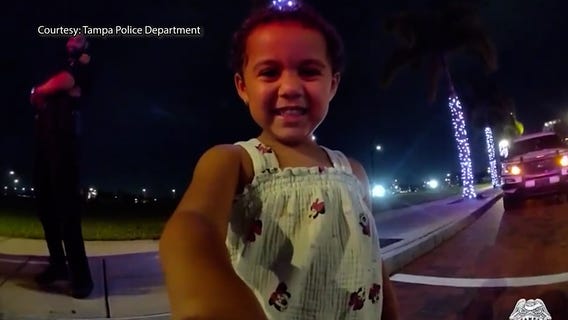 Curious girl inspects Tampa police officer's bodycam